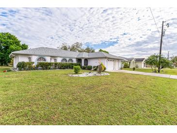 Single story home with a large yard, and two car garage at 41 Cabello St, Punta Gorda, FL 33983