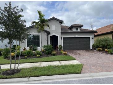Charming single-story home with a well-manicured lawn and a two-car garage at 2633 Daisy Dr, North Port, FL 34289