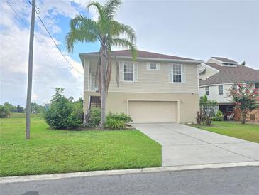 Two-story home with a garage and landscaping at 3263 Sea Grape Dr, Hernando Beach, FL 34607