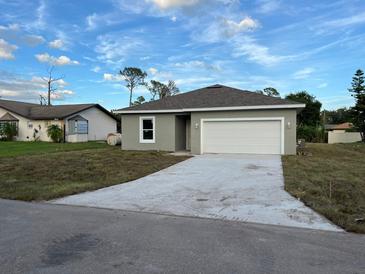 Newly constructed one-story home with a gray exterior at 1378 Wilmette St, Port Charlotte, FL 33980