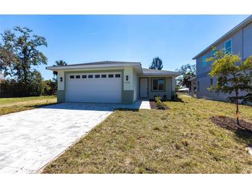 Charming single-story home with a two-car garage, fresh landscaping, and a modern, inviting facade at 5316 Altoona St, Sarasota, FL 34232