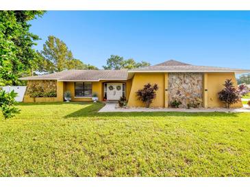 Single-story home with stone accents and a large yard at 12377 Fillmore St, Spring Hill, FL 34609