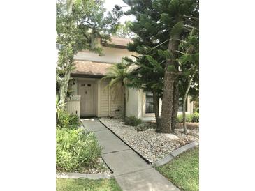 Inviting condo exterior with landscaped walkway at 5230 Linksman Pl # 2, North Port, FL 34287