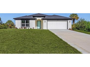 One-story home with a two-car garage and landscaped lawn at 3841 San Pedro Ave, North Port, FL 34288