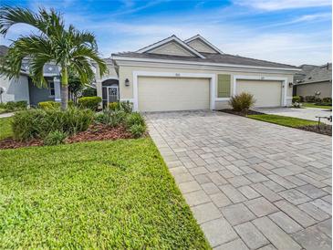 Front view of a two-car garage with paver driveway at 7615 Campus Cv, Sarasota, FL 34243