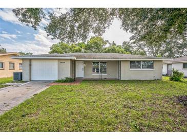 Ranch-style home with a white garage door at 10226 Willow Dr, Port Richey, FL 34668