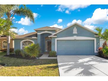 Well-maintained house with a two-car garage and landscaped front yard at 3002 Forest Fern Ct, Land O Lakes, FL 34638