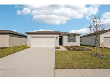 Single-story house with a two-car garage and landscaped yard at 180 Lazy Shore Dr, Nokomis, FL 34275