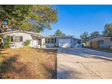 Ranch style home with attached garage and mature landscaping at 11357 116Th Ave, Largo, FL 33778