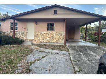 House exterior featuring a carport and stone accents at 6114 S 3Rd St, Tampa, FL 33611