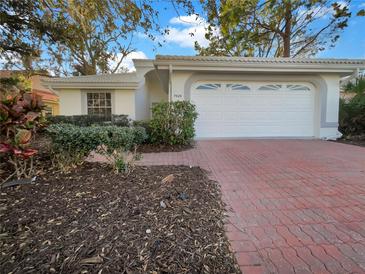 Single-Gathering home with brick driveway and landscaping at 7526 Fairlinks Ct, Sarasota, FL 34243