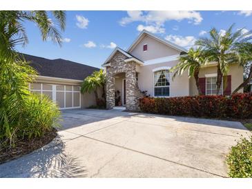Charming single-Gathering home showcasing a well-maintained front yard, lush landscaping, and a spacious driveway at 11909 Mandevilla Ct, Tampa, FL 33626