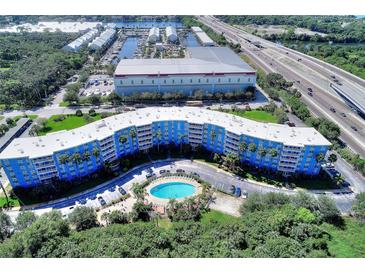Aerial view of a blue building with a pool, near a highway at 3315 58Th S Ave # 508, St Petersburg, FL 33712