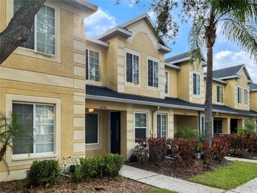 Exterior view of a yellow townhouse building at 10726 Keys Gate Dr, Riverview, FL 33579