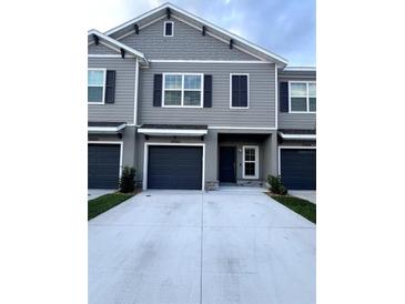 Modern gray two-story townhome with two-car garage at 10922 Brightleaf Ct, Riverview, FL 33569