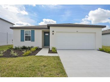 Charming single-story home featuring a two-car garage and beautifully landscaped front yard at 165 Lazy Shore Dr, Nokomis, FL 34275