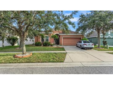 Single-Gathering home with a peach-colored exterior and a two-car garage at 612 Marion Hill Ln, Ruskin, FL 33570