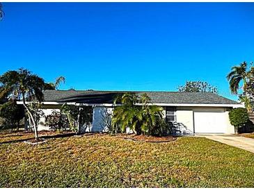 Charming single-story home with a well-maintained lawn and mature landscaping at 3310 W 63Rd W St, Bradenton, FL 34209