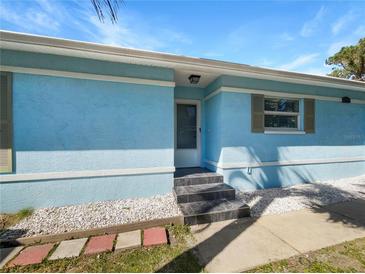 Light blue house exterior with a small front yard at 736 Mac Crillus Rd, Largo, FL 33770