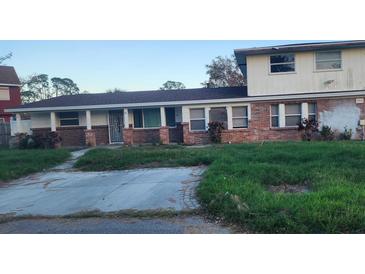 Brick ranch house with overgrown lawn and driveway at 1015 Linden Rd, Venice, FL 34293