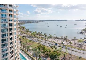 Stunning aerial view showcasing waterfront property, pool, and nearby marina at 340 S Palm Ave # 11, Sarasota, FL 34236