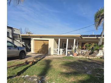 One-story house with a garage and a yard at 501 55Th Ave, St Pete Beach, FL 33706