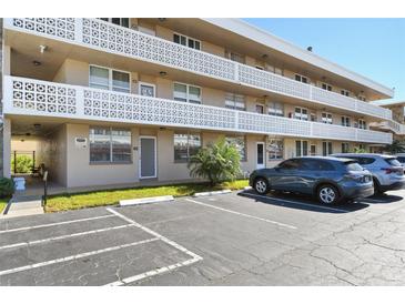 Exterior view of condo building with parking lot and landscaping at 5095 Bay Ne St # 109, St Petersburg, FL 33703