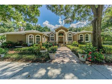 Beautiful home exterior with lush landscaping and a brick walkway at 5900 98Th N Ave, Pinellas Park, FL 33782