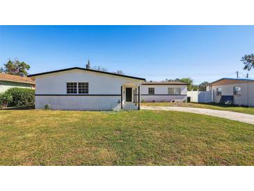 Charming single-story home with a well-maintained front lawn and classic curb appeal on a sunny day at 6007 Ambassador Dr, Tampa, FL 33615