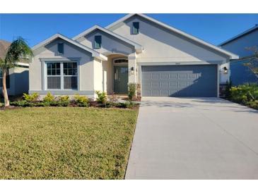 Two-story house with gray garage and landscaping at 7006 162Nd E Pl, Parrish, FL 34219