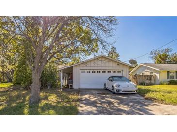 House exterior featuring a carport and a white car parked in the driveway at 6434 River Ridge Rd, New Port Richey, FL 34653