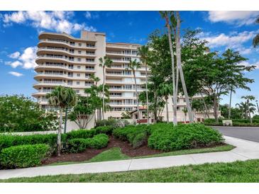 Grand Bay building exterior, lush landscaping, and gated entrance at 3010 Grand Bay Blvd # 472, Longboat Key, FL 34228