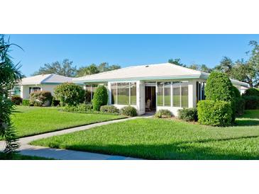 White single story home with a sunroom and well-manicured lawn at 6809 9Th W Ave # 0, Bradenton, FL 34209