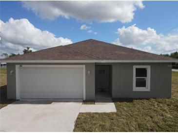 Front exterior of a single-story home with a one-car garage and a driveway at 1262 Oxsalida St, Port Charlotte, FL 33952
