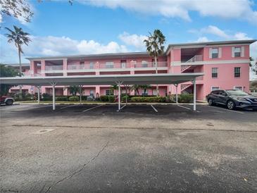 Pink apartment building exterior with covered parking at 2061 Willow Hammock Cir # 107, Punta Gorda, FL 33983