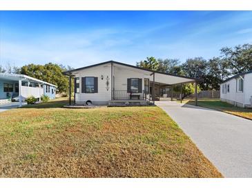 Charming single-story home with a carport and landscaped yard at 4920 Sedeno Dr, Zephyrhills, FL 33541