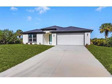 One-story home with attached garage and landscaped lawn at 1649 N San Mateo Dr, North Port, FL 34288