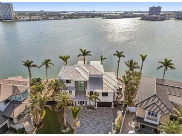 Aerial view of waterfront home with palm trees and a large driveway at 7801 9Th S Ave, St Petersburg, FL 33707