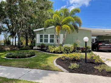 Attractive waterfront home with landscaped yard and palm trees at 8401 Imperial Cir, Palmetto, FL 34221