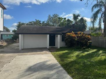 Cute bungalow with a nicely landscaped front yard and a paved driveway at 3524 Chapel Dr, Sarasota, FL 34234