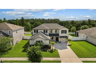 Two-story house with a landscaped yard and driveway at 12211 Streambed Dr, Riverview, FL 33579