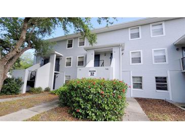 Building 32, light blue building with multiple units and landscaping at 7181 E Bank Dr # 103, Tampa, FL 33617