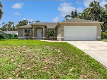 Charming single-story home featuring a two-car garage and well-maintained front yard at 3593 Junction St, North Port, FL 34288