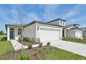 Charming single-Gathering home featuring a two-car garage, landscaped yard, and contemporary architecture at 14068 Crutchfield Ct, Parrish, FL 34219