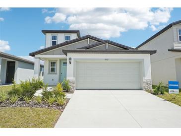 Charming two-story home featuring a two-car garage, and attractive landscaping at 3912 Radiant Mountain Dr, Plant City, FL 33565