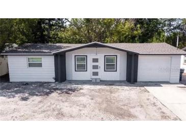 Charming single-story home featuring a new paint job, an attached one-car garage, and a spacious front yard at 3818 Moog Rd, Holiday, FL 34691