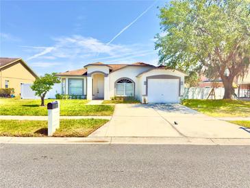 Charming single-story home featuring a well-manicured lawn and an attached two-car garage at 4604 Hunts Ave, Plant City, FL 33566