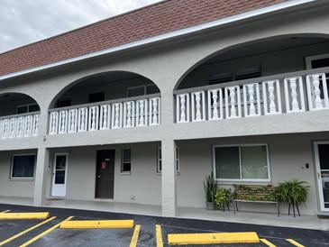 Condo building featuring a neutral color scheme, arched balconies, and well-maintained landscaping at 6026 22Nd N Ave # 4, St Petersburg, FL 33710