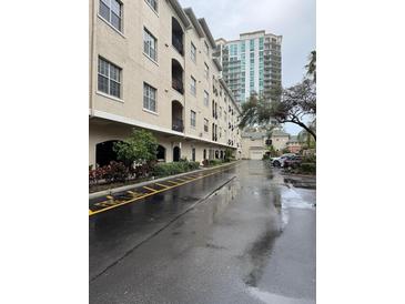 Exterior view of a multi-story condo complex with balconies and covered parking at 501 Knights Run Ave # 2106, Tampa, FL 33602