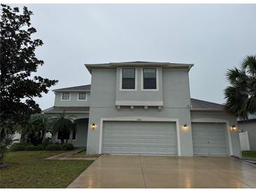 Charming two-story home featuring a spacious three-car garage and well-maintained landscaping at 7108 Harvest Glen Ln, Riverview, FL 33578